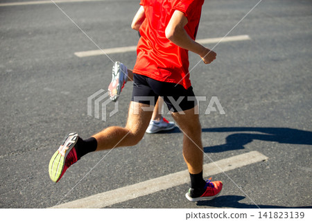 Two male runners running marathon Two male runners running marathon 141823139