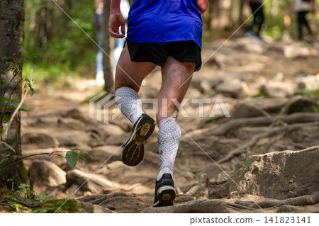 Male runner in compression socks running Male runner in compression socks running 141823141