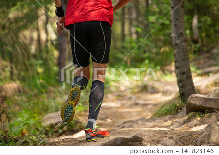 Rear view male runner in compression socks running Rear view male runner in compression socks running 141823146