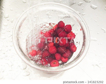 Wash the berries in a clear bowl Wash the berries in a clear bowl 141823202