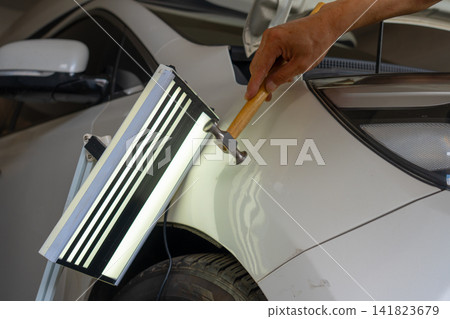Removing dents on the car. PDR technology. Car body repair without painting. Removing dents on the car. PDR technology. Car body repair without painting. 141823679