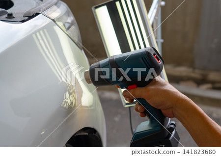 Removing dents on the car. PDR technology. Car body repair without painting. Removing dents on the car. PDR technology. Car body repair without painting. 141823680