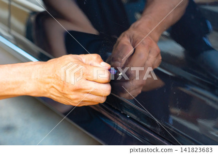 Removing dents on the car. PDR technology. Car body repair without painting. Removing dents on the car. PDR technology. Car body repair without painting. 141823683