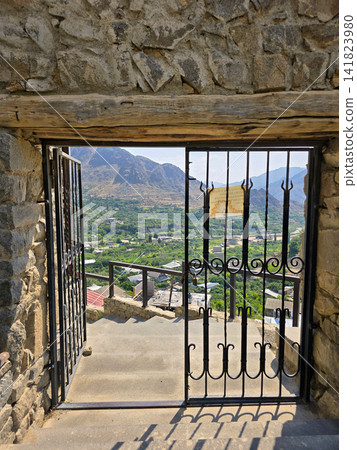 View through open gate from stone structure, overlooking valley and mountains View through open gate from stone structure, overlooking valley and mountains 141823980