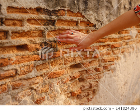 Woman Hand Touching Ancient Red Brick Wall Close Up Woman Hand Touching Ancient Red Brick Wall Close Up 141824390