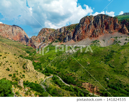 Aerial view of high cliffs and lush green valley Aerial view of high cliffs and lush green valley 141824535