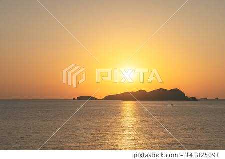 Sa Conillera in a Platges de Comte sunset view with small boat and copy space. Sa Conillera in a Platges de Comte sunset view with small boat and copy space. 141825091