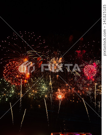 Colorful fireworks exploding in the dark night sky during a festive celebration Colorful fireworks exploding in the dark night sky during a festive celebration 141825185
