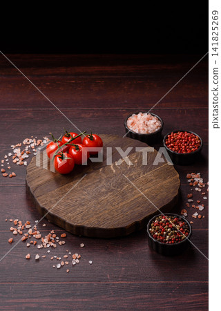 A square wooden cutting board for home food preparation. A wooden cutting board A square wooden cutting board for home food preparation. A wooden cutting board 141825269