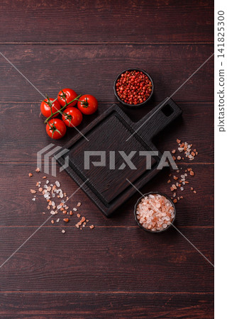 A square wooden cutting board for home food preparation. A wooden cutting board A square wooden cutting board for home food preparation. A wooden cutting board 141825300