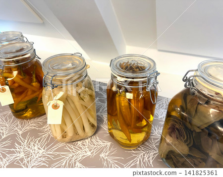 Pickled vegetables in glass jars on shelf Pickled vegetables in glass jars on shelf 141825361