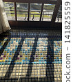 The tiled floor is illuminated by sunlight streaming in from outside the sunroom of Tamahime, a Western-style building at Kiunkaku in Atami. 141825559