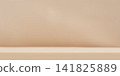 Beige studio room wall with tabletop. Minimal clean background for product presentation. Neutral interior scene for mockup and branding. 141825889