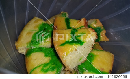 Close up shot of green patterned sponge cake that has been cut. 141826066