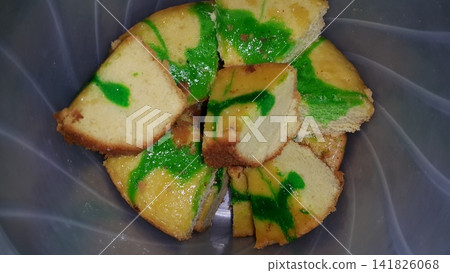 Close up shot of green patterned sponge cake that has been cut. Close up shot of green patterned sponge cake that has been cut. 141826068