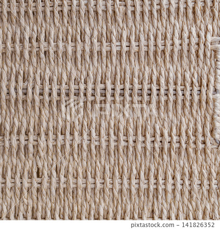 Detailed close up texture of light brown storage basket made of twisted paper twine weaving Detailed close up texture of light brown storage basket made of twisted paper twine weaving 141826352