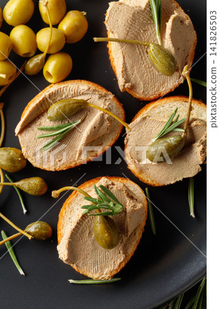 Sandwiches with pate on a black plate. Sandwiches with pate on a black plate. 141826503