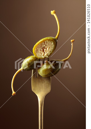 Canned capers on a fork. Canned capers on a fork. 141826510