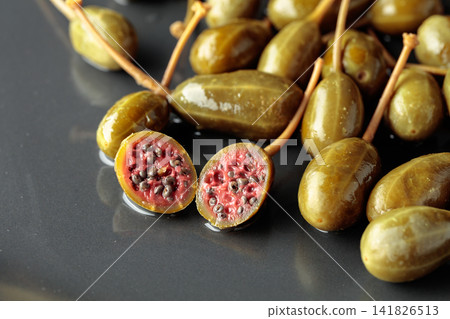 Canned capers on a black plate. Canned capers on a black plate. 141826513
