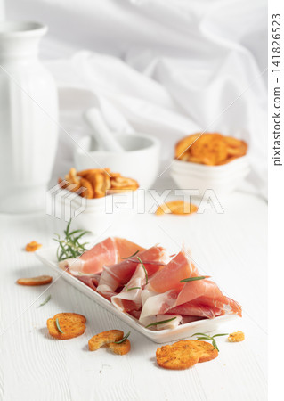 Prosciutto with rosemary and spicy bruschetta crackers. Prosciutto with rosemary and spicy bruschetta crackers. 141826523