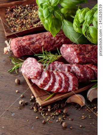 Sliced smoked sausage with herbs and spices. Sliced smoked sausage with herbs and spices. 141826539