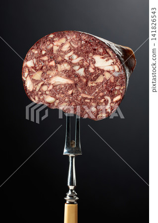Black pudding or blood sausage on a fork. Black pudding or blood sausage on a fork. 141826543