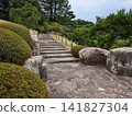 The quiet stone steps and trimmed hedges of the Sankei-en Japanese garden lead up to the blue sky. 141827304