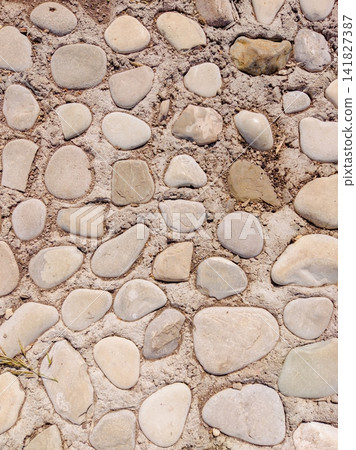 Round stones arranged on dry sandy ground Round stones arranged on dry sandy ground 141827387