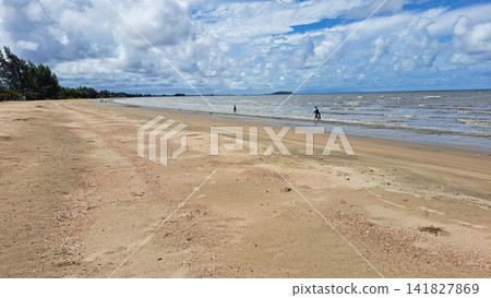Scenic sandy beach coast and blue ocean under cloudy sky. Scenic sandy beach coast and blue ocean under cloudy sky. 141827869