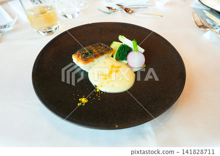 The harmony of white fish and sauce enjoyed at a restaurant. The harmony of white fish and sauce enjoyed at a restaurant. 141828711