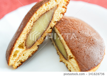 A cross-section of a refreshing dorayaki with melting lemon bean paste filling. A cross-section of a refreshing dorayaki with melting lemon bean paste filling. 141828736