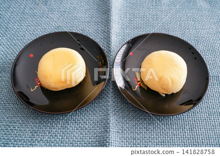 A steamed bun with a fluffy dough and a rich custard filling. A steamed bun with a fluffy dough and a rich custard filling. 141828758