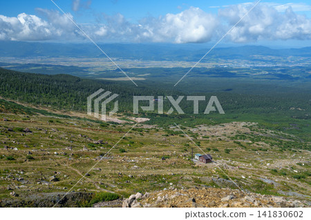 Climbing Mt. Tokachi in Hokkaido: Views of the towns of Biei and Furano, and the magnificent mountain scenery from the hiking trail. Climbing Mt. Tokachi in Hokkaido: Views of the towns of Biei and Furano, and the magnificent mountain scenery from the hiking trail. 141830602