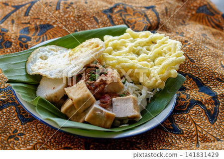 Traditional Indonesian Tahu Campur with Fried Egg and Crackers Traditional Indonesian Tahu Campur with Fried Egg and Crackers 141831429