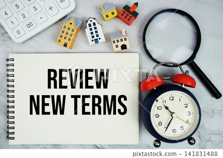 Review New Terms text written on notepad with house model, calculator, magnifying glass and alarm clock on marble background Review New Terms text written on notepad with house model, calculator, magnifying glass and alarm clock on marble background 141831488