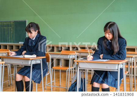 Junior high and high school students in uniform taking entrance exams, tests, and examinations. Junior high and high school students in uniform taking entrance exams, tests, and examinations. 141831908