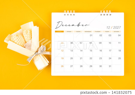 2027 December desk calendar and Yellow bouquet on yellow background. 2027 December desk calendar and Yellow bouquet on yellow background. 141832075