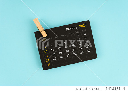 Black calendar sheet for January 2027 with wooden clips. Black calendar sheet for January 2027 with wooden clips. 141832144