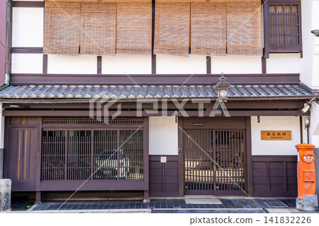 Kyoto, Shinmachi Street: A traditional Kyoto townhouse belonging to the long-established Taisei Textile shop, and a round post box (Type 1 round postbox). Kyoto, Shinmachi Street: A traditional Kyoto townhouse belonging to the long-established Taisei Textile shop, and a round post box (Type 1 round postbox). 141832226