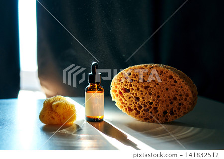 Natural skincare essence with sea sponges capturing light Natural skincare essence with sea sponges capturing light 141832512