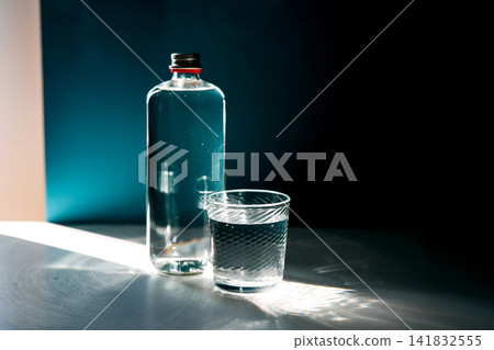 Water bottle and glass filled with clear liquid Water bottle and glass filled with clear liquid 141832555