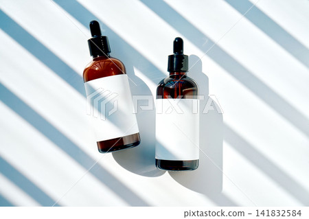 Skincare serum dropper bottles in dynamic light and shadow Skincare serum dropper bottles in dynamic light and shadow 141832584