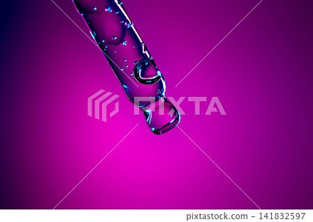 Pipette drawing cosmetic serum with bubbles on vibrant background Pipette drawing cosmetic serum with bubbles on vibrant background 141832597