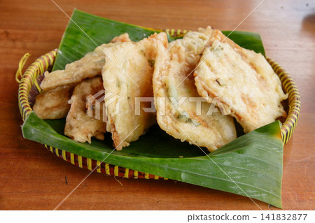 Traditional Indonesian Tempe Mendoan Battered Fried Tempeh on Banana Leaf Traditional Indonesian Tempe Mendoan Battered Fried Tempeh on Banana Leaf 141832877
