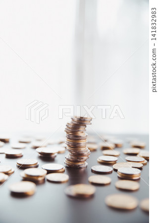 Unstable stack of coins surrounded by scattered money on a desk, symbolizing financial risk, economic uncertainty, fragile savings, market volatility, budget imbalance, and investment challenges. Unstable stack of coins surrounded by scattered money on a desk, symbolizing financial risk, economic uncertainty, fragile savings, market volatility, budget imbalance, and investment challenges. 141832983
