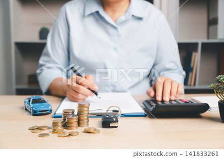 Car finance concept with toy car, coin stacks, calculator, key, and paperwork, representing auto loan payment, vehicle insurance, savings, budget, and purchase cost planning. Car finance concept with toy car, coin stacks, calculator, key, and paperwork, representing auto loan payment, vehicle insurance, savings, budget, and purchase cost planning. 141833261