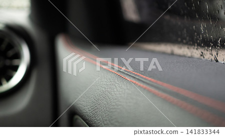 Red stitch on black leather of luxury sports car Red stitch on black leather of luxury sports car 141833344