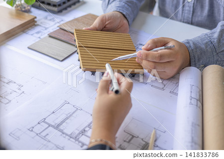 Closeup of Creative Architecture, Interior, Engineering Team Discussing Blueprint Layout and Renovation Materials. Closeup of Creative Architecture, Interior, Engineering Team Discussing Blueprint Layout and Renovation Materials. 141833786