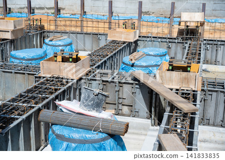 A scene from a residential construction site showing foundation work and rebar placement. A scene from a residential construction site showing foundation work and rebar placement. 141833835
