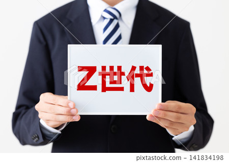 一位身穿西裝的年輕商人手持白板,代表Z世代。 一位身穿西裝的年輕商人手持白板,代表Z世代。 141834198